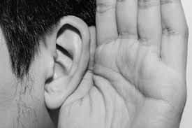 Picture of ear and hand around it, in a "listening" position